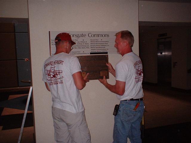 Ed Herkert and son, Eric, Getting the Plaque in Place